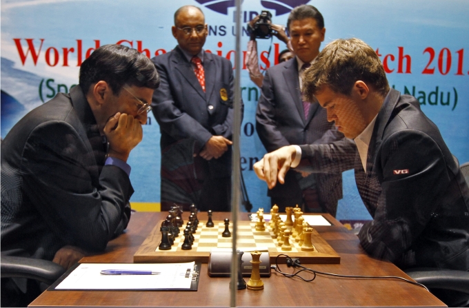 Magnus Carlsen  makes a move against India's Viswanathan Anand during the FIDE World Chess Championship in the southern Indian city of Chennai November 9, 2013. REUTERSBabu