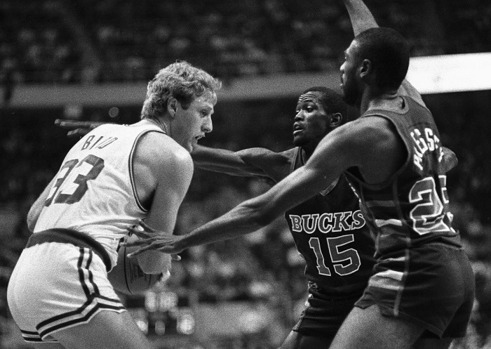 Celtics' Larry Bird is double-teamed by Milwaukee Bucks Craig Hodges (150 and Paul Pressey as Bird tries to pass ball off during 1st quarter action of the game at Boston Garden, 12/19