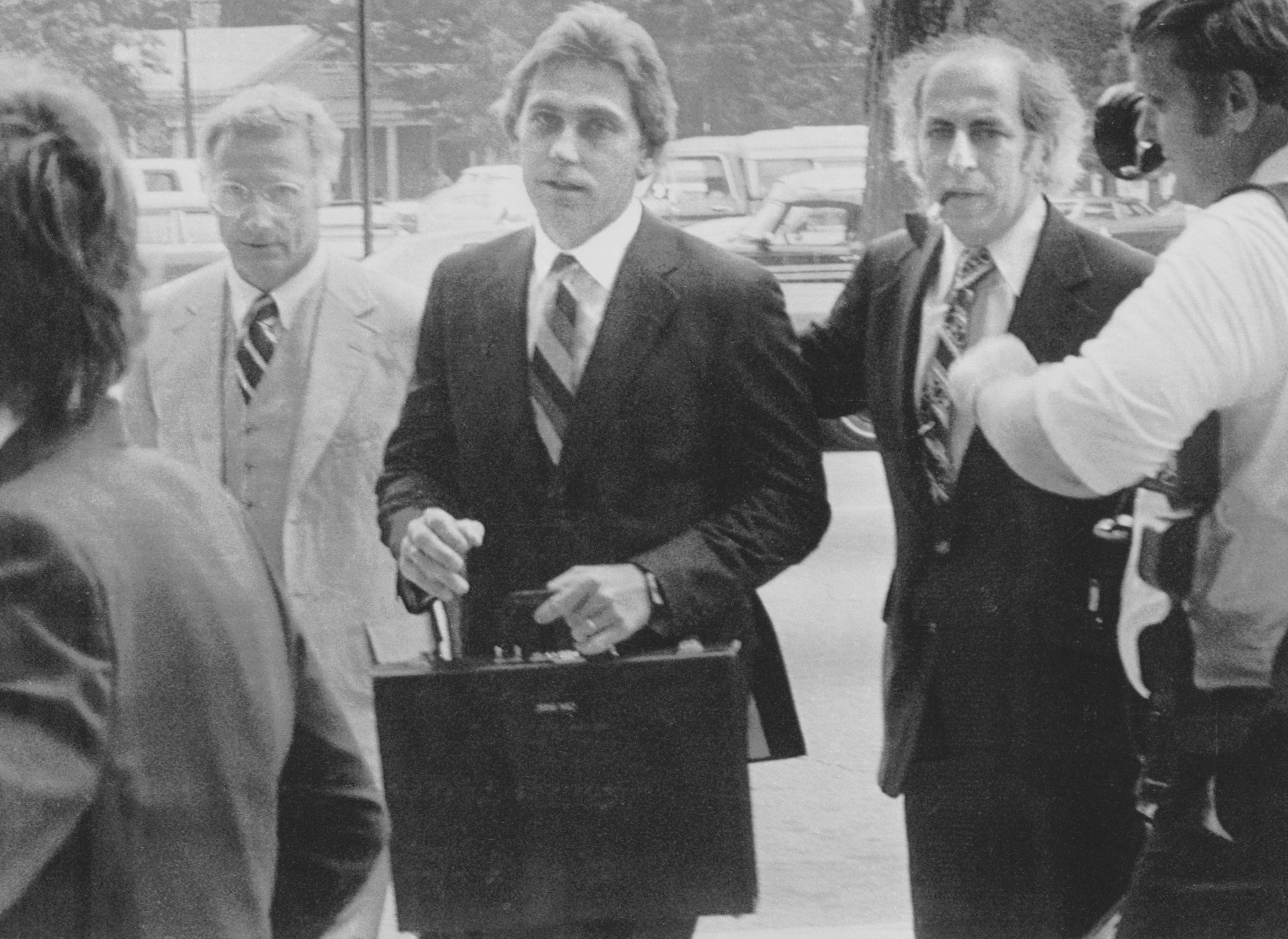 16 Jul 1979, Raleigh, North Carolina, USA --- Original caption: July 16, 1979 - Raleigh, North Carolina: Dr. Jeffrey MacDonald (center), nine and a half years after his pregnant wife and two young daughters were killed in a Fort Bragg, North Carolina apartment, entered the Federal Courthouse to stand trial for their deaths. With him are attorneys Wade Smith (left) and Bernard Segal (right). The former Army doctor told newsmen he believes he will be found innocent. The trial was expected to last six to eight weeks. --- Image by © Bettmann/CORBIS