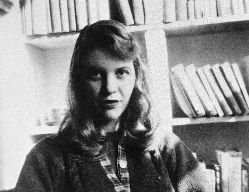 1950s-1963 --- Original caption: Photo shows author Sylvia Plath seated in front of a bookshelf. --- Image by © Bettmann/CORBIS