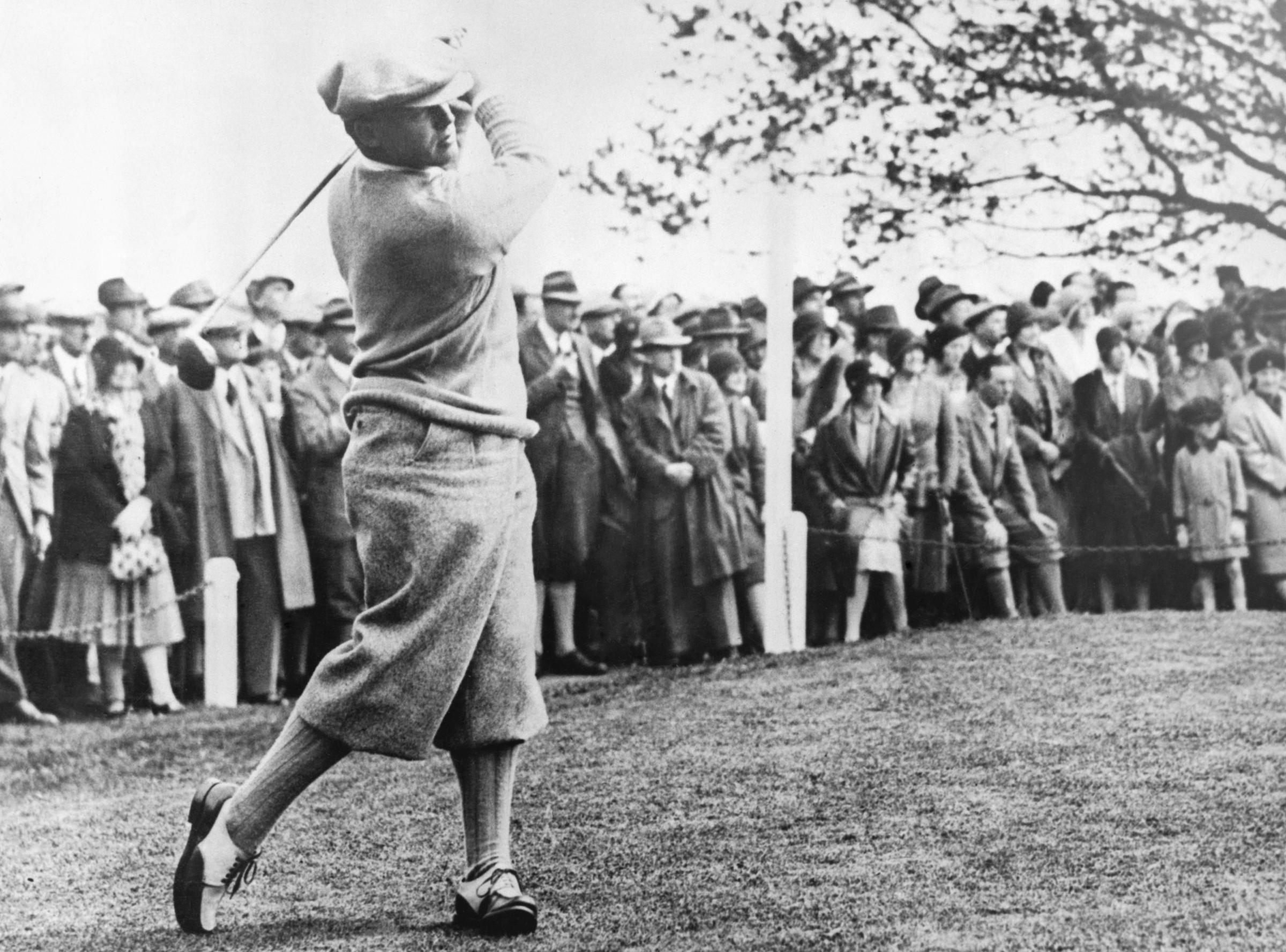 ca. 1900s --- Original caption: Bobby Jones (b. 1902) American golfer and only player ever to make the "Grand Slam". Photograph full-length swinging golf club. --- Image by © Corbis
