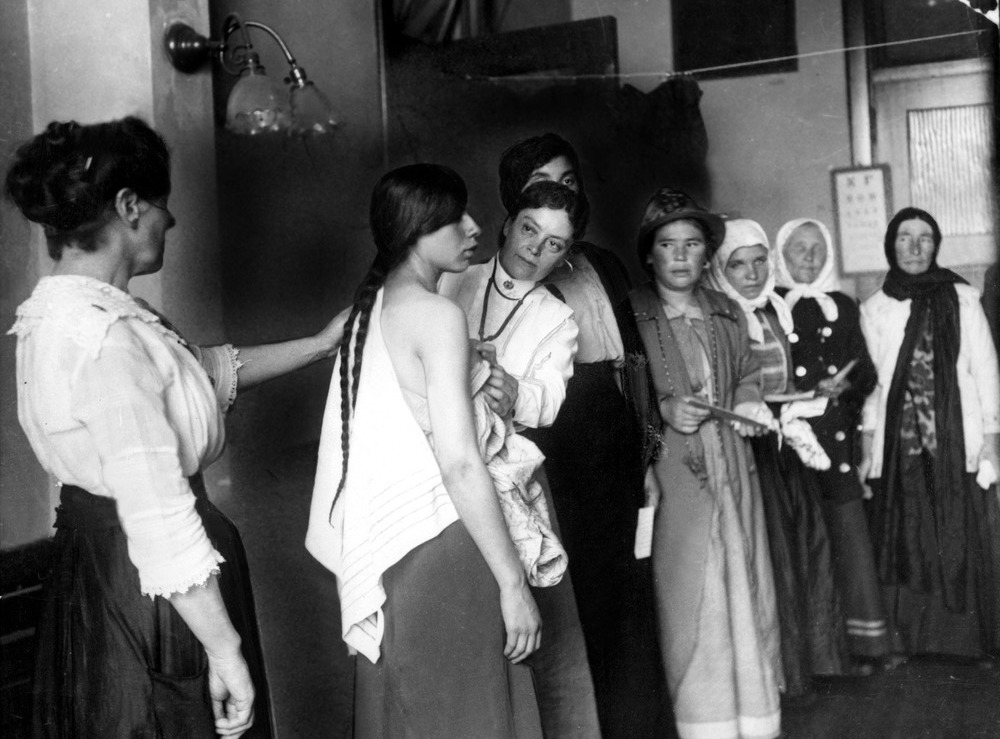 Women immigrants undergoing a physical examination at Ellis Island, N.Y., about 1910