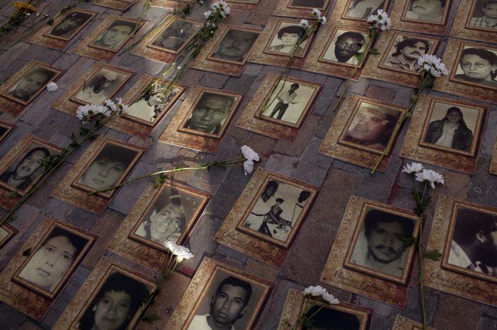 Several portraits lie on the street to commemorate the disappeared during the peace signature between the Colombian government and the Revolutionary Armed Forces of Colombia, FARC guerrillas yesterday in Bolivar's plaza. Bogota, September 26, 2016. After four years of negotiations in Havana, Cuba, both the the government of Colombia and FARC rebels agreed to peace, ending a 52 year old war that left at least 300,000 dead and 5 million people displaced. *** Local Caption *** 14876616
