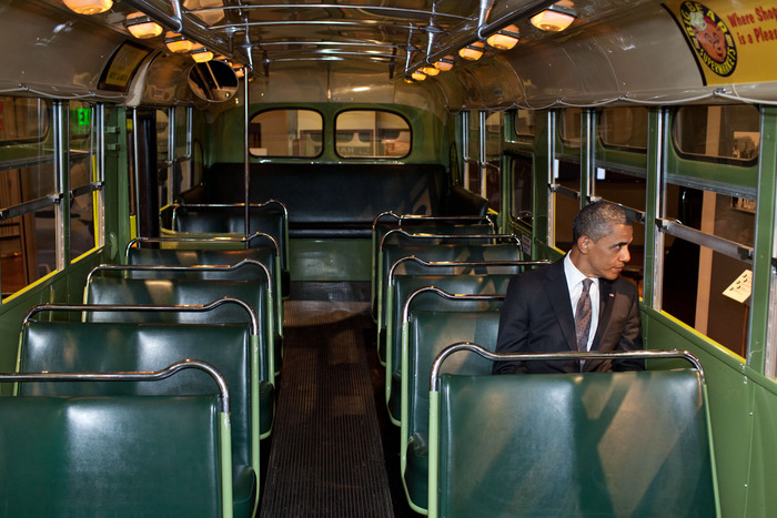 President Barack Obama sits on the famed Rosa Parks bus at the Henry Ford Museum following an event in Dearborn, Michigan, April 18, 2012. (Official White House Photo by Pete Souza) This official White House photograph is being made available only for publication by news organizations and/or for personal use printing by the subject(s) of the photograph. The photograph may not be manipulated in any way and may not be used in commercial or political materials, advertisements, emails, products, promotions that in any way suggests approval or endorsement of the President, the First Family, or the White House.Ê