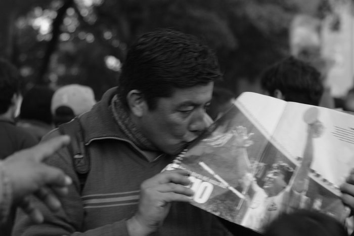 Buenos Aires, Argentina. 9th July 2014 -- An Argentine fan kisses a picture of Diego Maradona with the 1986 World Cup, during the semifinal against The Netherlands. -- Argentine football fans met in San Martin Square of Buenos Aires, to watch the FIFA World Cup semifinal against The Netherlands. Argentina defeated The Netherlands, and will go on to the World Cup Final.