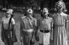 25th July 1952:  Four young dancers of the Italia Conti School compete in a potato eating contest in Green Park, London. They are (L to R) Frances Reynolds of Palmers Green, Sonia Hoey of Hampton Court, Maureen Bullion of Catford and Elizabeth Hewitt of Erith in Kent.  (Photo by Reg Speller/Keystone/Getty Images)