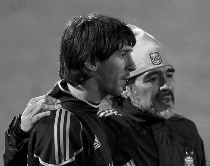Argentina’s coach Diego Maradona walks alongside Lionel Messi after a practice soccer session in Pretoria
