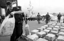 Spanish police unload sacks of cocaine from a Belgian-flagged catamaran, totalling nearly three tonnes, at the port in Vilagarcia de Arousa, northwestern Spain, June 15 2005. Police said two Belgians and an Albanian were arrested on the boat which contained the haul. Police arrested another 11 people in Galicia, northwest Spain, and five in southern Spain. REUTERS/Miguel Vidal