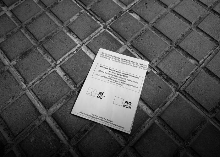 A paper copy of a referendum ballot is seen outside a Unipost office which was raided in search of material for the proposed October 1 referendum, in Terrassa