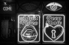 General view of neon signs outside a peep show and adult video shop in Soho, central London.