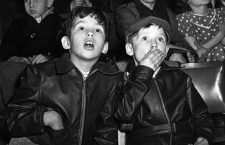 16th December 1954:  Two boys, captivated by the trapeze act at the circus, gaze in awe.  (Photo by Monty Fresco/Topical Press Agency/Getty Images)