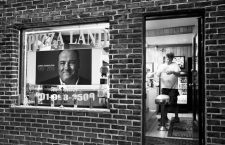 A delivery driver checks the order before leaving Pizza Land restaurant, which was featured in the television series "The Sopranos", as a memorial to deceased actor James Gandolfini is seen in its front window in North Arlington, New Jersey June 20, 2013. Gandolfini, best known for his Emmy-winning role as a mob boss in the "The Sopranos", passed away on Wednesday of an apparent heart attack. He was 51.      REUTERS/Carlo Allegri  (UNITED STATES - Tags: ENTERTAINMENT OBITUARY BUSINESS FOOD TPX IMAGES OF THE DAY)CODE: X02452