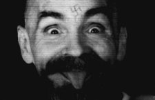 FILE PHOTO -  Charles Manson clowns around as he is led to his cell upon the conclusion of his exclusive interview with Reuters August 25, 1989. REUTERS/File PhotoCODE: X80002