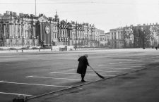 April 30, 1984 - Leningrad, Russia - In early morning a Russian woman sweeps the Palace Square, the central city square of Leningrad (St. Petersburg). In background the faÃ§ade of the Winter Palace, part of the Hermitage Museum, is decorated for the annual May Day Parade with reviewing stands and portraits of the Central Committee of the Communist Party of the USSR. At right a giant banner with an image of Vladimir Lenin, Communist revolutionary and first leader of the USSR, covers a building faÃ§ade. (Credit Image: © Arnold Drapkin/ZUMA Wire)