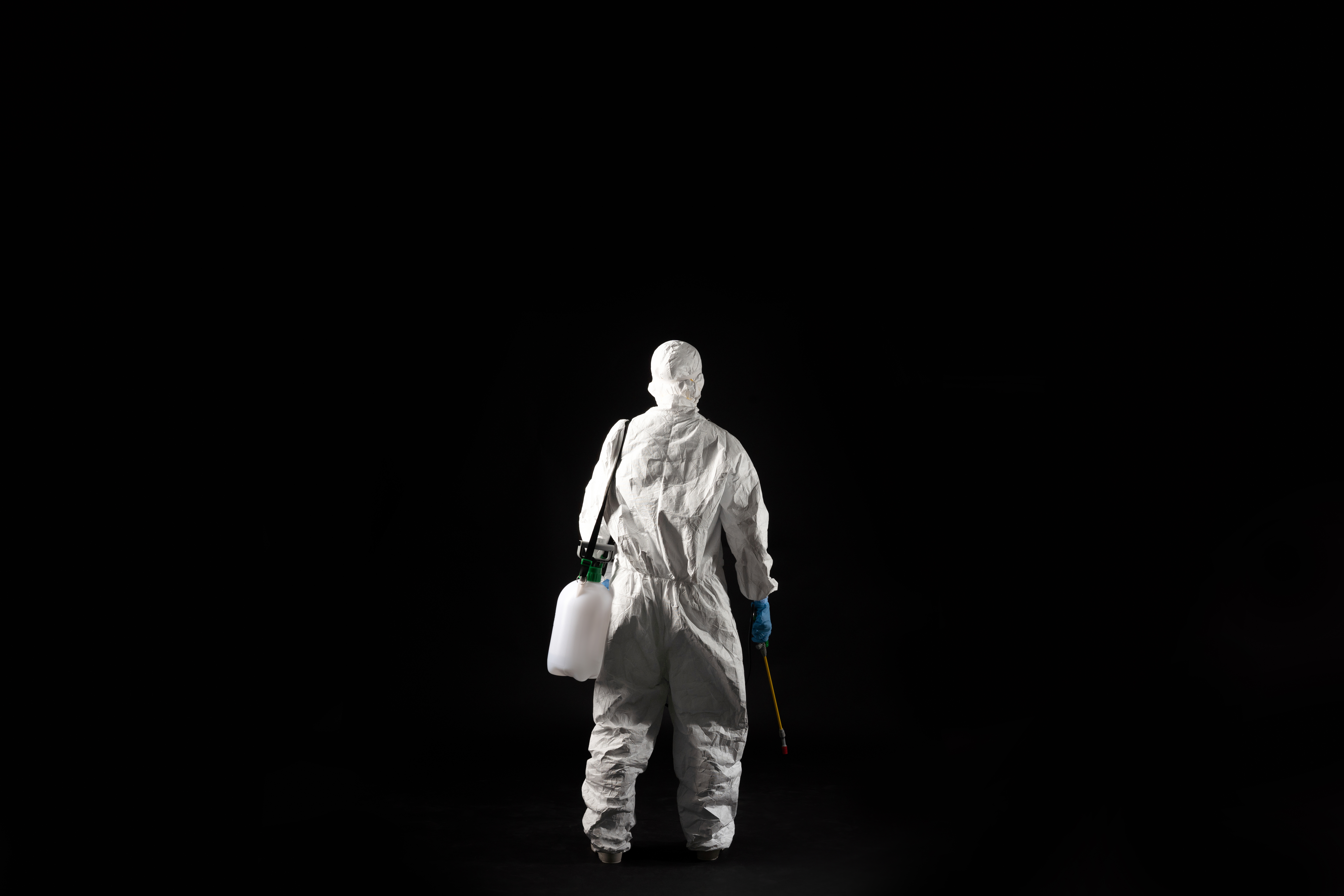 female virologist, she wears PPE.He stands back.