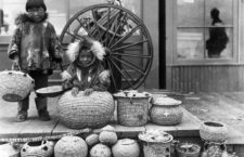 (Original Caption) 1904-Teller, AK: The Klondike Goldrush. Eskimo handmade baskets, Teller, Alaska, with two native Eskimo boys. Photograph by F. H. Nowell, 1904.