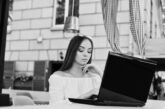 portrait strong independent successful businesswoman wearing smart casual clothing glasses working laptop cafe black white photo