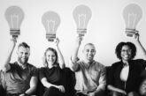 people carrying light bulb icons